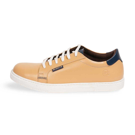The Gold Standard beige low-top sneakers with a sleek, clean silhouette.