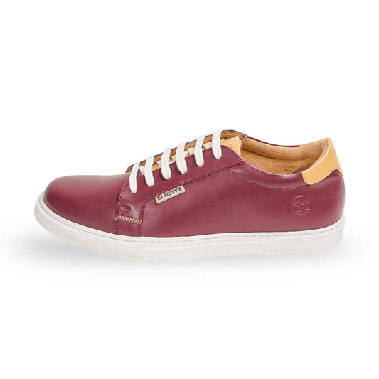 The Scarlet Standard low-top sneakers in rich burgundy with a saddle stitch pattern.